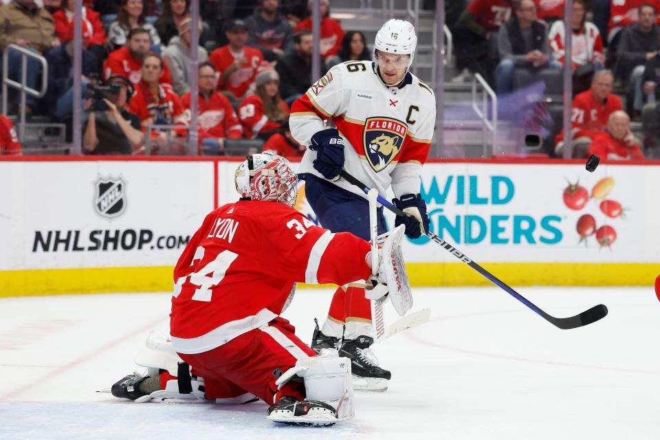 Detroit Red Wings goaltender Alex Lyon makes a save in front of Florida Panthers center Aleksander Barkov in the third period at Little Caesars Arena on Saturday, March 2, 2024, in Detroit, Michigan.