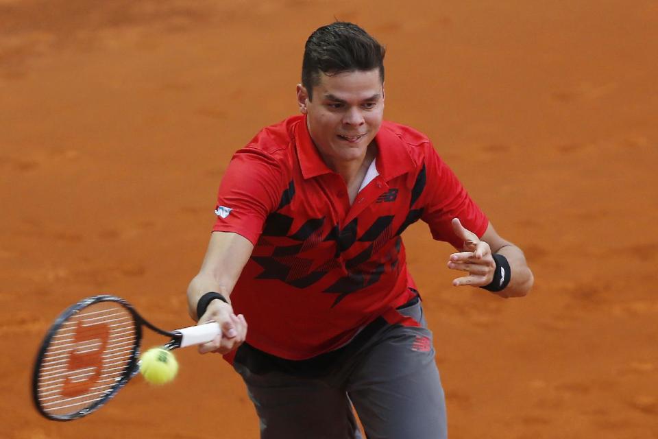 Milos Raonic from Canada returns the ball during a Madrid Open tennis tournament match against Jeremy Chardy from France, in Madrid, Spain, Tuesday, May 6, 2014. (AP Photo/Andres Kudacki)