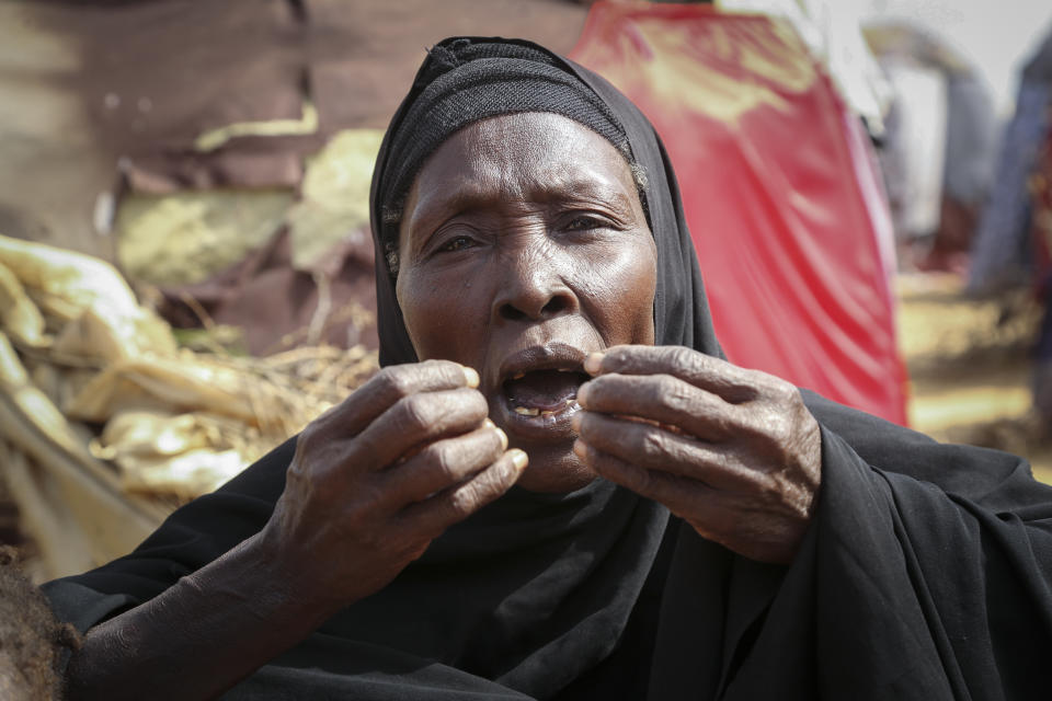 Dhahabo Isse, 60, describes how she fled from the drought without food or water causing four of her children to die of hunger, outside her makeshift tent at a camp for the displaced on the outskirts of Mogadishu, Somalia Thursday, June 30, 2022. The war in Ukraine has abruptly drawn millions of dollars away from longer-running humanitarian crises and Somalia is perhaps the most vulnerable as thousands die of hunger amid the driest drought in decades. (AP Photo/Farah Abdi Warsameh)