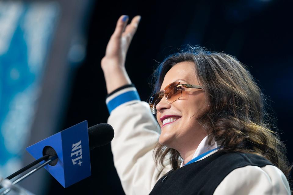Michigan Gov. Gretchen Whitmer wears her signature Buff sunglasses as she announces Giovanni Manu, a tackle from British Columbia, as the Detroit Lions' selection with the 126th pick on Saturday, April 27, 2024, the third day of the NFL draft in Detroit.