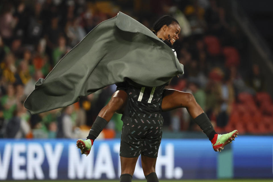 Nigeria's Blessing Demehin, back, celebrate with Nigeria's Osinachi Ohale after the Women's World Cup Group B soccer match between Ireland and Nigeria in Brisbane, Australia, Monday, July 31, 2023. (AP Photo/Tertius Pickard)