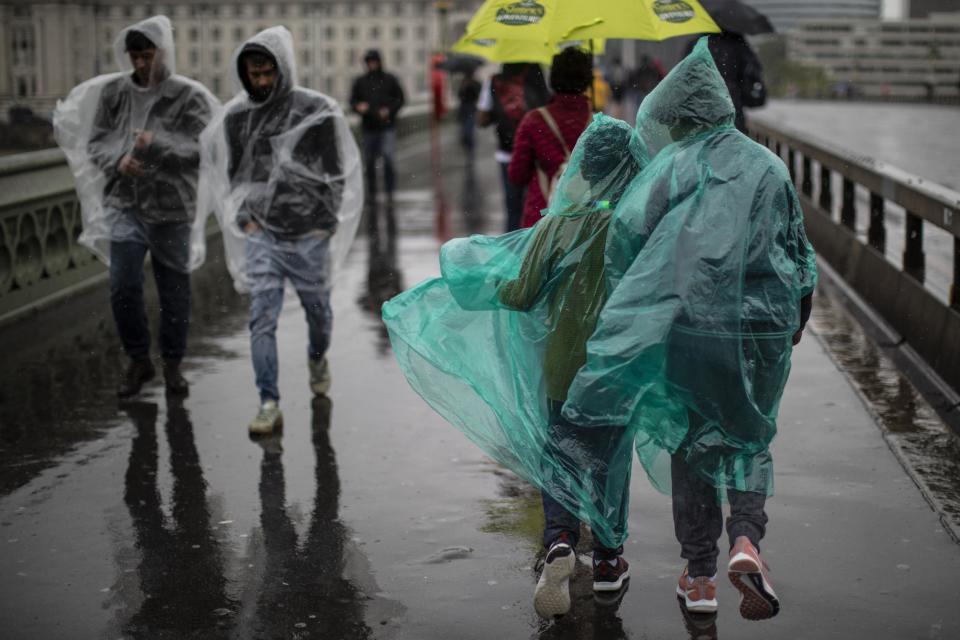 Members of the public walk through torrential rain on Westminster Bridge on August 14, 2019 in London: Getty Images