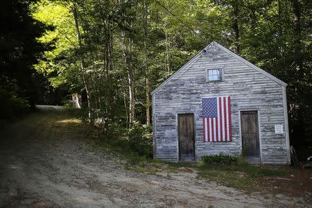 A U.S. flag hangs on the Friends School House in Weare, New Hampshire September 8, 2014, one day before the state's primary election. REUTERS/Brian Snyder