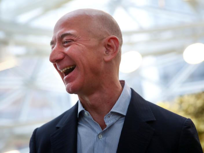 FILE PHOTO: Amazon founder and CEO Jeff Bezos laughs as he talks to the media while touring the new Amazon Spheres during the grand opening at Amazon&#39;s Seattle headquarters in Seattle, Washington, U.S., January 29, 2018.   REUTERS/Lindsey Wasson