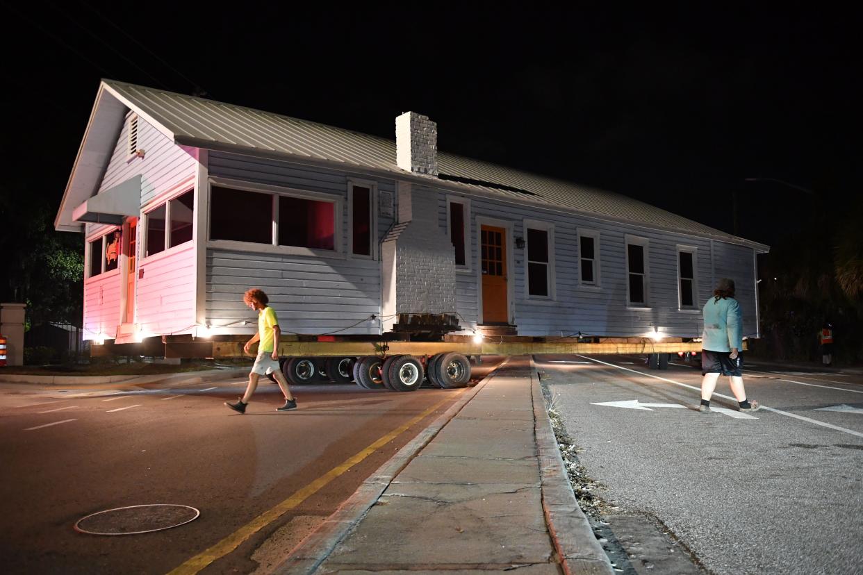 The historic Leonard Reid House straddles the median on Lemon Avenue near Ninth Street early Friday morning on the way to its new location. The structure was relocated from Seventh Street in the Rosemary District to a City of Sarasota-owned lot on Dr. Martin Luther King Way and Orange Avenue in Sarasota, where it will become the home of a new Sarasota African American cultural arts center.