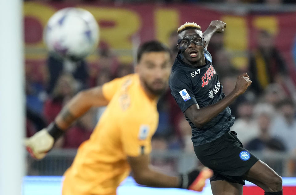 Victor Osimhen, derecha, del Napoli, anota el gol de su equipo durante el partido de fútbol de la Serie A en contra de Roma, en el Estadio Olímpico, el domingo 23 de octubre de 2022, en Roma (AP Foto/Andrew Medichini)