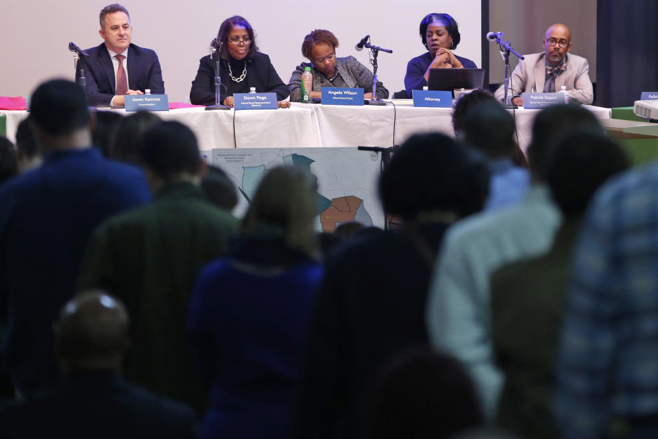 In this Dec. 16, 2019, photo, speakers wait to talk during the Richmond School Board's last public hearing on redistricting at Ginter Park Elementary School in Richmond, Va. In Virginia’s capital city, the school board approved a plan that reassigned some students but rejected more sweeping proposals that would have diversified Richmond’s whitest elementary schools. (AP Photo/Steve Helber)