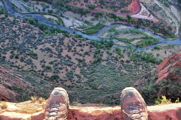 A pair of shoes on the edge of a cliff.