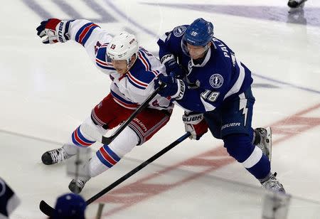 Tampa Bay Lightning left wing Ondrej Palat (18) battles with New York Rangers right wing Jesper Fast (19) during the third period in game six of the Eastern Conference Final of the 2015 Stanley Cup Playoffs at Amalie Arena. Mandatory Credit: Reinhold Matay-USA TODAY Sports