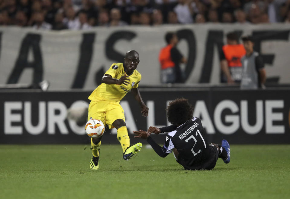 Chelsea's N'Golo Kante, left, duels for the ball with PAOK's Diego Biseswar during a Group L Europa League soccer match between PAOK and Chelsea at Toumba stadium in the northern Greek port city of Thessaloniki, Thursday, Sept. 20, 2018. (AP Photo/Thanassis Stavrakis)