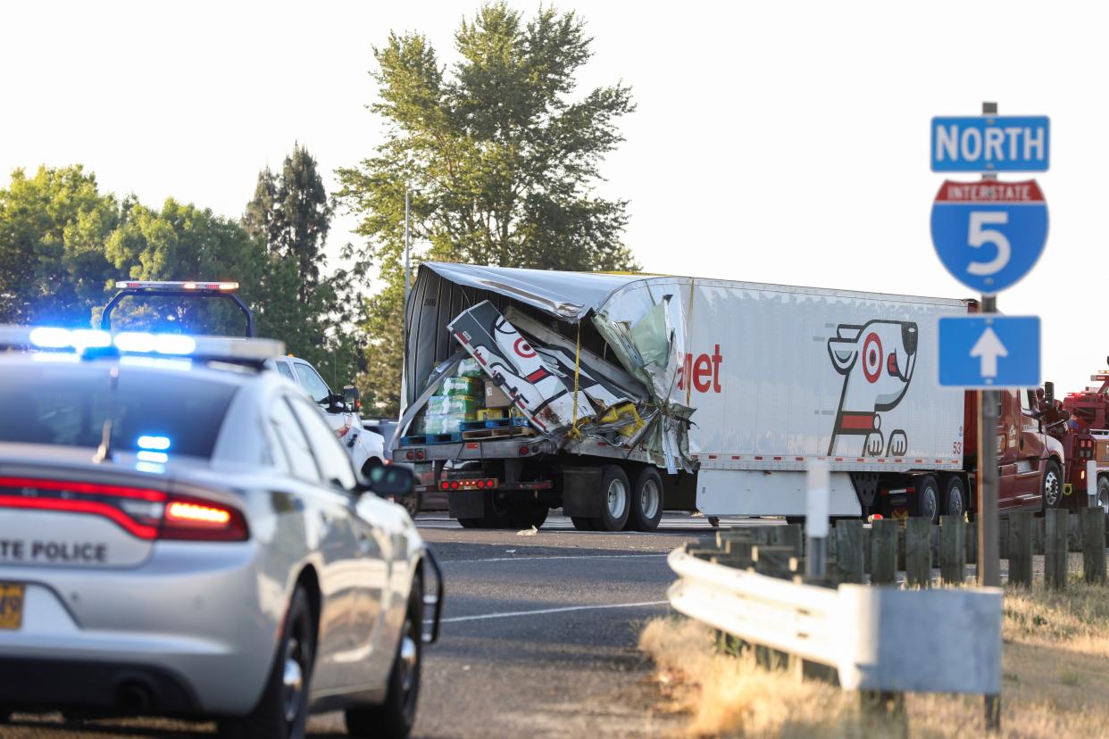 A semitruck is towed hours after a three-vehicle crash on Interstate 5 between Salem and Albany claimed the lives of at least seven adults, on Thursday, May 18, 2023.