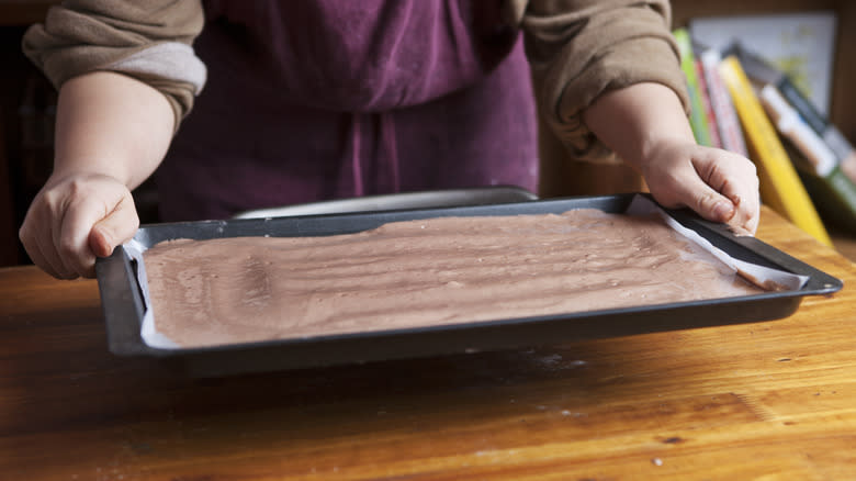 Person making jelly roll cake