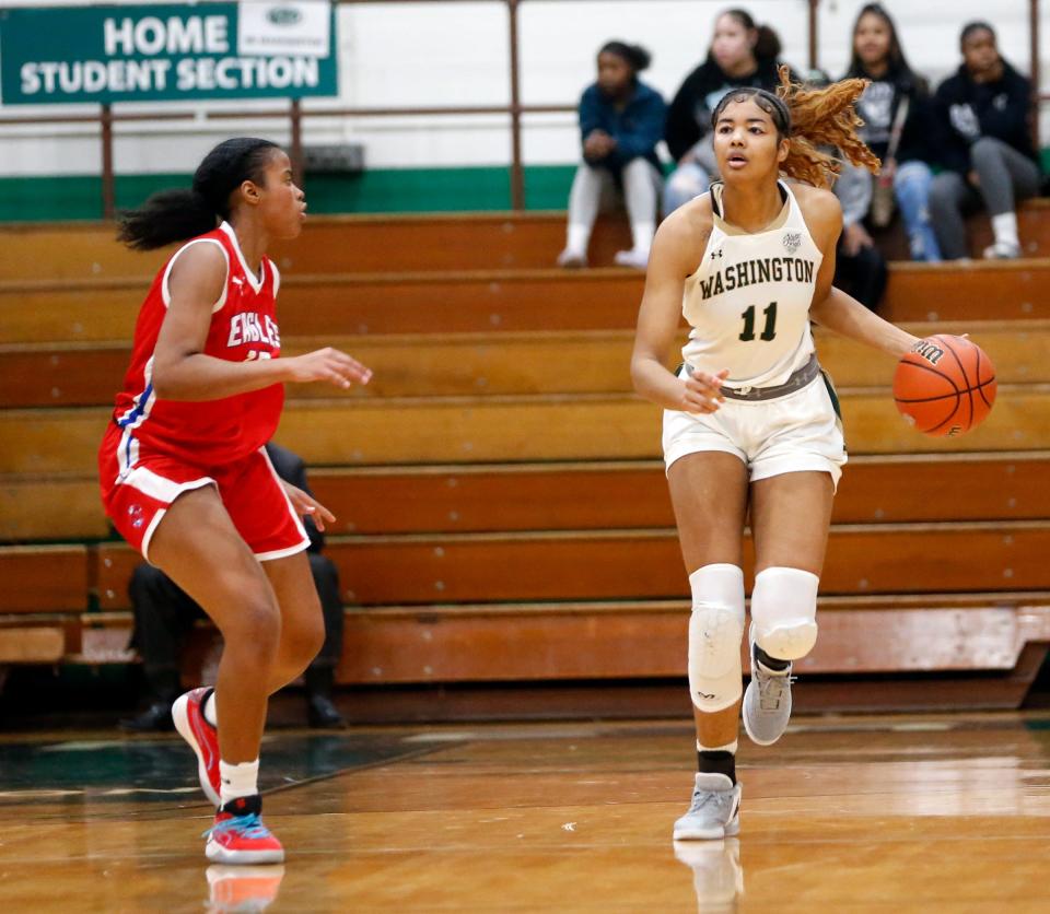 South Bend Washington junior Kira Reynolds (11) brings the ball up the court while being defended by South Bend Adams junior Zariyah Wiley during the Class 4A, Sectional 3 girls basketball championship game Saturday, Feb. 3, 2024, at Washington High School.