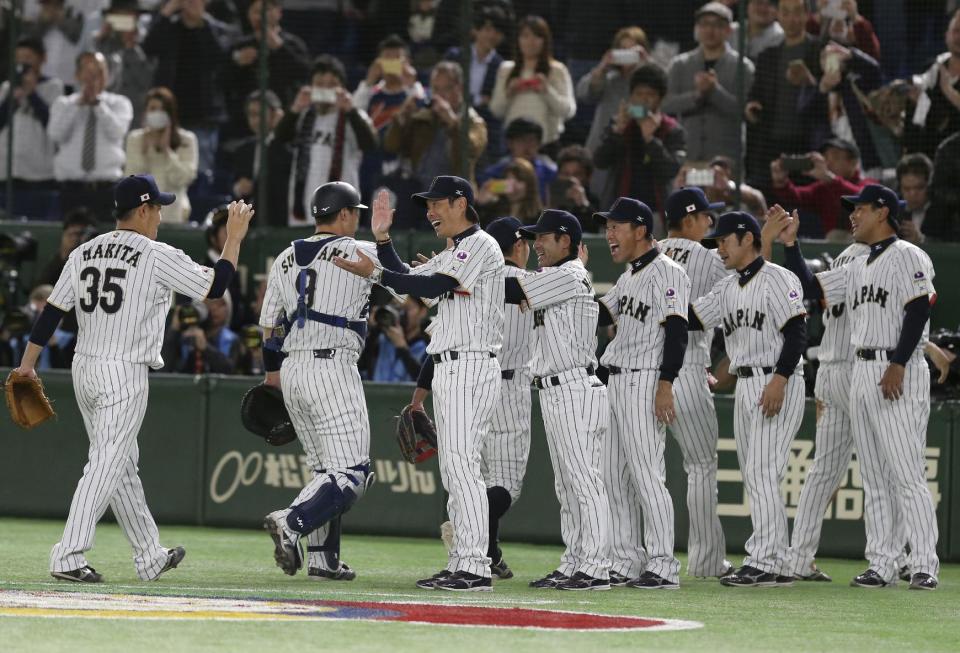 Japan's manager Hiroki Kokubo, third from left, celebrates with his players after beating Cuba 8-5 in31 their second round game at the World Baseball Classic at Tokyo Dome in Tokyo, Tuesday, March 14, 2017. (AP Photo/Toru Takahashi)