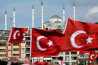 <p>People carry Turkish flags they walk towards the July 15 Martyr’s bridge on a “National Unity March” to commemorate the one year anniversary of the July 15, 2016 botched coup attempt, in Istanbul, Saturday, July 15, 2017. (Photo: Emrah Gurel/AP) </p>