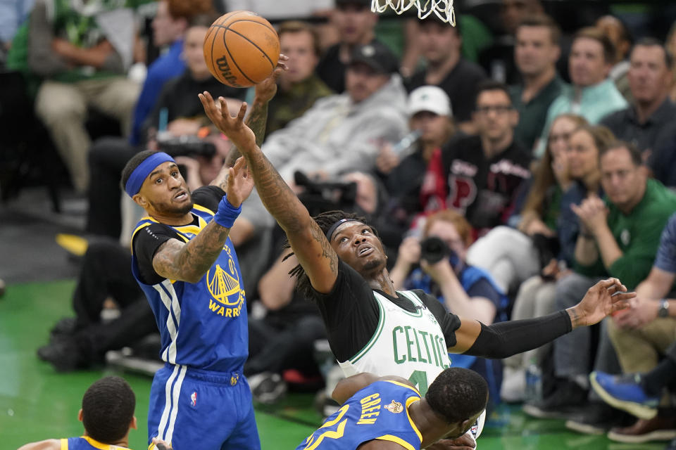 Boston Celtics center Robert Williams III (44) ad nGolden State Warriors guard Gary Payton II (0) battle for a rebound during the first quarter of Game 6 of basketball's NBA Finals, Thursday, June 16, 2022, in Boston. (AP Photo/Steven Senne)