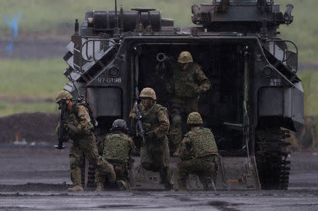 Japanese Ground Self-Defense Force members take part in an annual training session near Mount Fuji at Higashifuji training field in Gotemba, Japan August 23, 2018. REUTERS/Kim Kyung-Hoon/Files