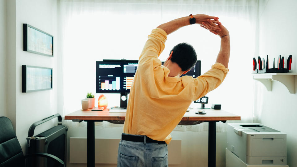 person stretching at their desk
