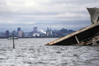 A section of the damaged and collapsed Francis Scott Key Bridge is seen, in the Baltimore port, Monday, April 1, 2024. (Kaitlin Newman/The Baltimore Banner via AP)