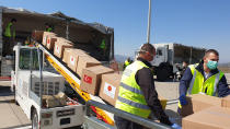 In this handout photo provided by the Turkish Defense Ministry, Serbian officials unload Personal Protection Equipment donated by Turkey to help the country combat the new coronavirus outbreak, in Belgrade, Serbia, Wednesday, April 8, 2020. The new coronavirus causes mild or moderate symptoms for most people, but for some, especially older adults and people with existing health problems, it can cause more severe illness or death (Turkish Defence Ministry via AP)