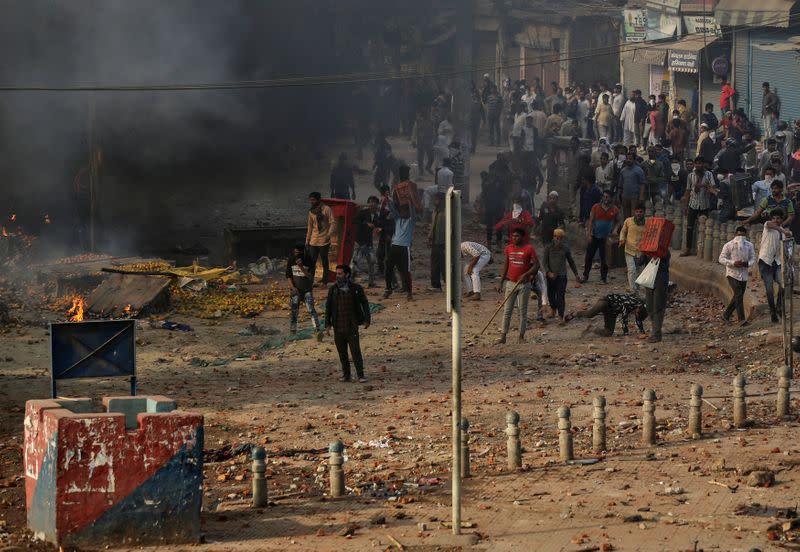 People supporting a new citizenship law and those opposing the law, clash during a protest in New Delhi