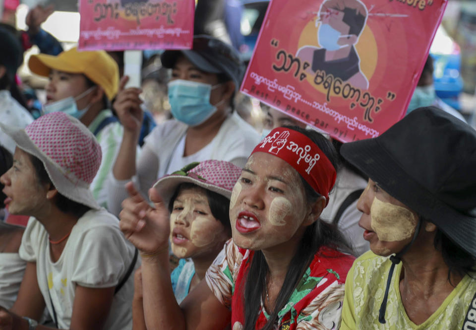 Anti-coup protesters display an image of protester who was shot and killed by Myanmar security forces during a protest two-days earlier as they gather to protest in Yangon, Myanmar Tuesday, Feb. 23, 2021. Protesters gathered in Myanmar's biggest city despite the ruling junta's threat to use lethal force against people who join a general strike against the military's takeover three weeks ago. (AP Photo)