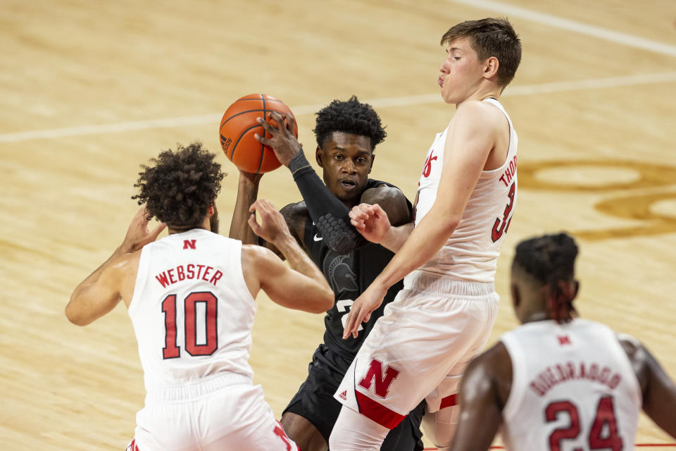 Michigan State guard Rocket Watts (2) looks to pass against Nebraska guard Kobe Webster (10) and Nebraska guard Thorir Thorbjarnarson (34) in the first half during an NCAA college basketball game on Saturday, Jan. 2, 2021, in Lincoln, Neb. (AP Photo/John Peterson)