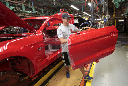 FILE PHOTO: A Ford Motor assembly worker works on a Ford Mustang vehicle at the Ford Motor Flat Rock Assembly Plant in Flat Rock, Michigan, August 20, 2015. REUTERS/Rebecca Cook/File Photo