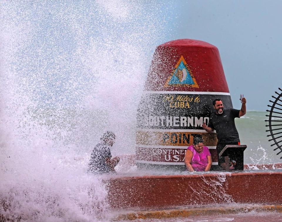 Key West resident Pedro Lara takes selfie in front of the Southernmost Point in the USA monument as waves from Hurricane Irma crash over the wall, September 9, 2017.