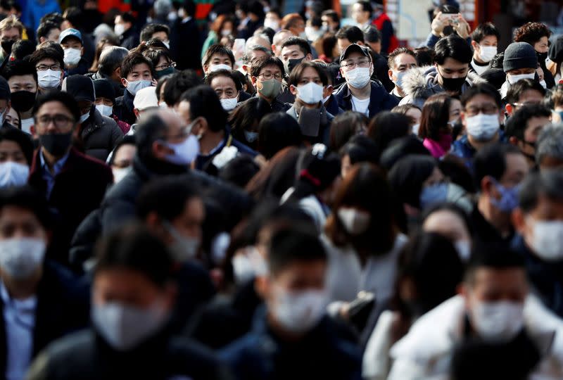 Visitors wearing protective face masks wait to offer prayers on the first business day of the New Year at the Kanda Myojin shrine, frequented by worshippers seeking good fortune and prosperous business, amid the coronavirus disease (COVID-19) outbreak in T