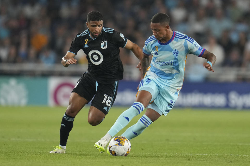 Colorado Rapids forward Calvin Harris, right, controls the ball as Minnesota United forward Ismael Tajouri-Shradi challenges during the first half of an MLS soccer match, Wednesday, Aug. 30, 2023, in St. Paul, Minn. (AP Photo/Abbie Parr)