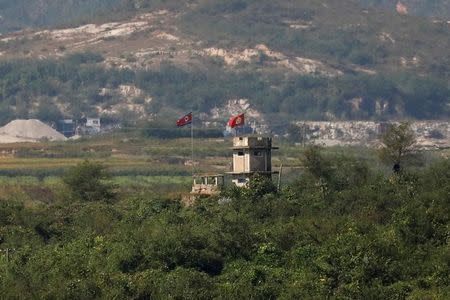 FILE PHOTO - A North Korean flag flutters at a guard post near the propaganda village of Gijungdong in North Korea, in this picture taken near the truce village of Panmunjom, South Korea, September 28, 2017. REUTERS/Kim Hong-Ji