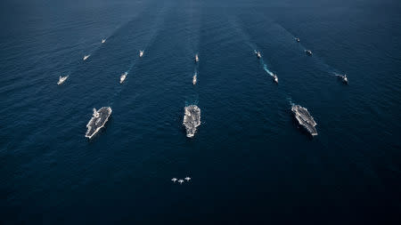 FILE PHOTO - Three F/A-18E Super Hornets fly in formation over the aircraft carriers USS Ronald Reagan (CVN 76), USS Theodore Roosevelt (CVN 71), USS Nimitz (CVN 68) and their strike groups along with ships from the Republic of Korea Navy as they transit the Western Pacific, November 12, 2017. Courtesy Aaron B. Hicks/U.S. Navy/Handout via REUTERS/File Photo