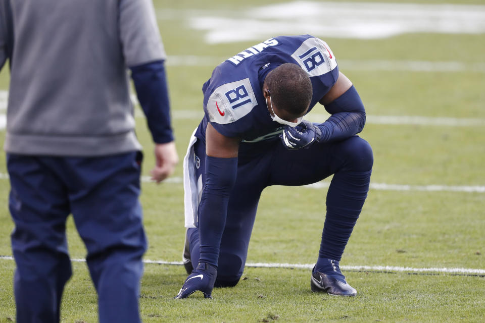 Tennessee Titans tight end Jonnu Smith kneels on the field after losing to the Baltimore Ravens in an NFL wild-card playoff football game Sunday, Jan. 10, 2021, in Nashville, Tenn. The Ravens won 20-13. (AP Photo/Wade Payne)