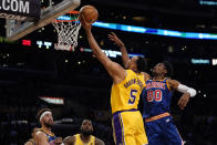 Los Angeles Lakers guard Talen Horton-Tucker (5) shoots against Golden State Warriors forward Jonathan Kuminga (00) during the first half of an NBA basketball game in Los Angeles, Saturday, March 5, 2022. (AP Photo/Ashley Landis)