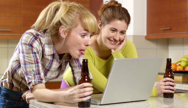 Young women social networking with tongue out