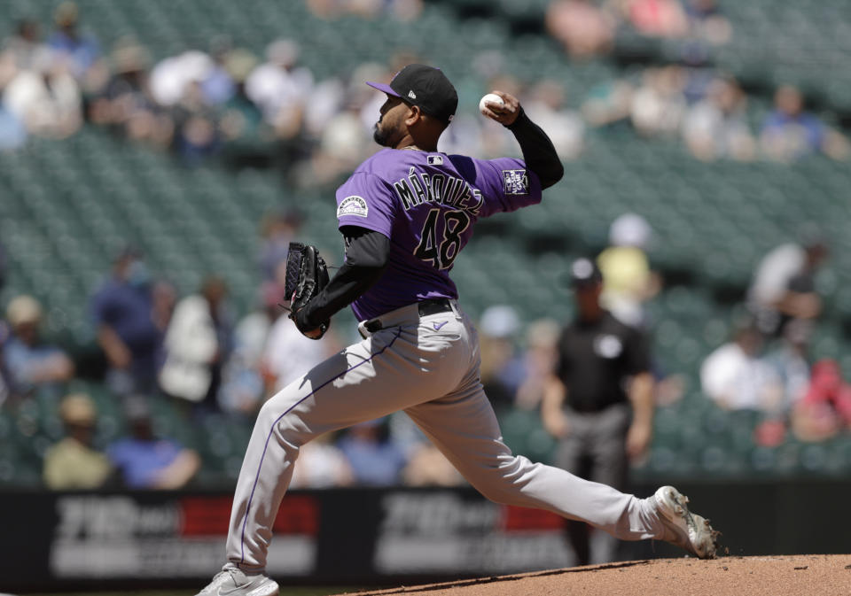 Colorado Rockies starting pitcher German Marquez works agains the Seattle Mariners during the first inning of a baseball game, Wednesday, June 23, 2021, in Seattle. (AP Photo/John Froschauer)