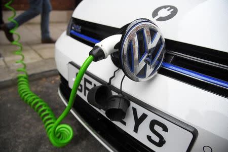 An electric Volkswagen car is plugged into a recharging point in central London, Britain November 10, 2016. REUTERS/Toby Melville /Files