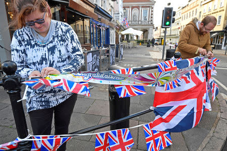 People string up bunting, on the day before the royal wedding of Britain's Princess Eugenie and Jack Brooksbank, in Windsor, Britain, October 11, 2018. REUTERS/Hannah McKay