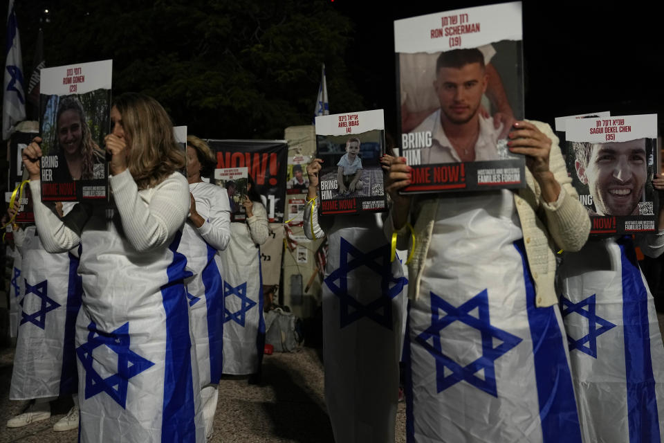 Relatives and friends of hostages held in the Gaza Strip by the Hamas militant group call for their release in the Hostages Square at the Museum of Art in Tel Aviv, Israel, Saturday Dec. 2, 2023. (AP Photo/Ariel Schalit))