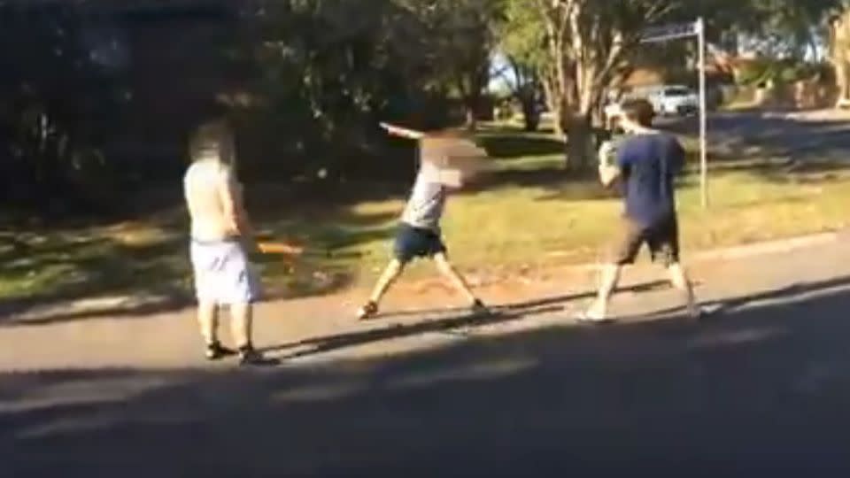 The men meet in the middle of a street in Killarney Vale, bearing weapons. Photo: Facebook