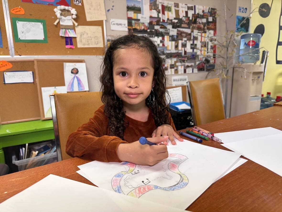 Ava Smirknob, 6, colours a drawing at the Cabbagetown Community Arts Centre. The centre is asking for financial help to keep its doors open. (Talia Ricci/CBC - image credit)