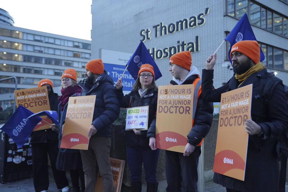 Junior doctors and members of the British Medical Association (BMA) demonstrate outside St Thomas' Hospital, London, Wednesday, Jan. 3, 2024, as they take to picket lines for six days. Doctors in the early stages of their careers in England have started a 72-hour strike in their long-running dispute over pay levels. (Jonathan Brady/PA via AP)