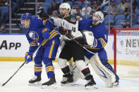 Buffalo Sabres defenseman Mark Pysyk (13) and Arizona Coyotes forward Andrew Ladd (16) battle for position in front of Sabres goalie Dustin Tokarski (31) during the second period of an NHL hockey game, Saturday, Oct. 16, 2021, in Buffalo, N.Y. (AP Photo/Jeffrey T. Barnes)