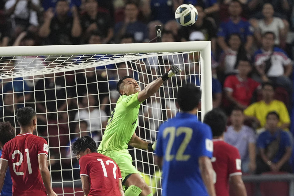 Singapore goalkeeper Hassan Sunny saves the ball from Thailand's during their World Cup Asia qualifying match at Rajamangala national stadium in Bangkok, Thailand, Tuesday, June 11, 2024. Chinese football fans poured their love to a Singaporean goalkeeper's restaurant payment account after his performance in a game on Tuesday allows China takes a further step to be the World Cup 2026. (AP Photo/Pattarchai Pramarnpanich)