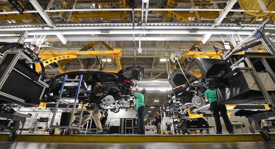 Workers on the assembly line at the Mercedes-Benz U.S. International plant in Vance put components on the new electric EQS SUV on Thursday, Aug. 25, 2022.