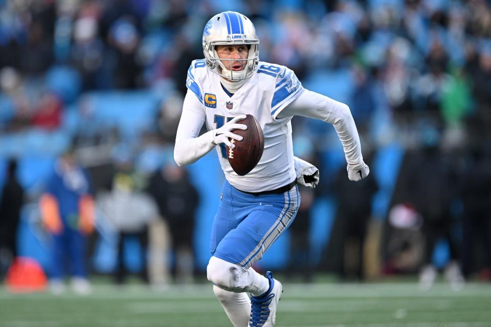 Jared Goff of the Detroit Lions carries the ball in the second half against the Carolina Panthers at Bank of America Stadium on Dec. 24, 2022 in Charlotte, North Carolina.
