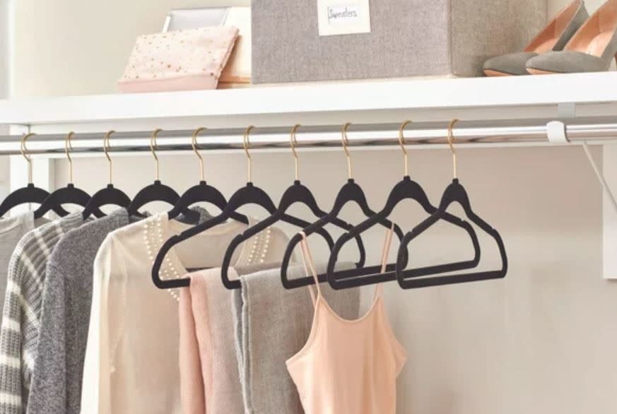 black velvet hangers with gold hooks in closet