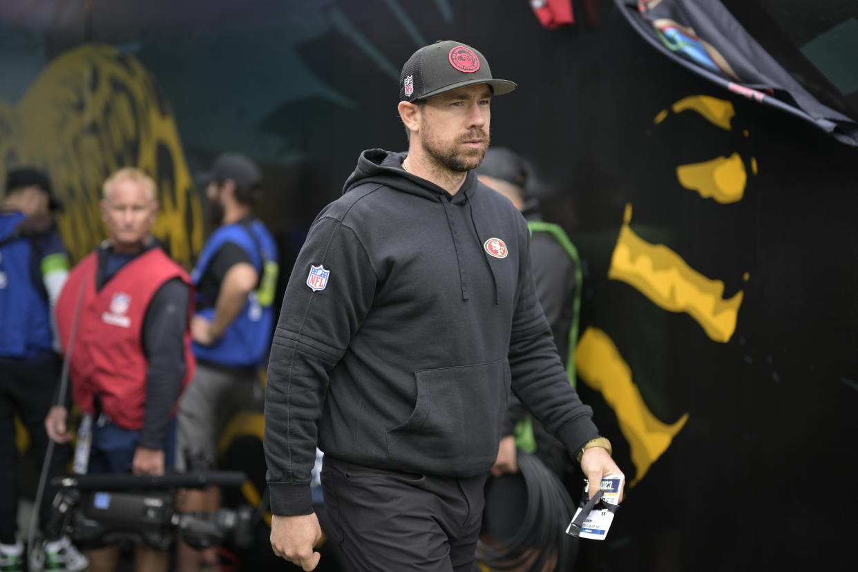 San Francisco 49ers offensive passing game specialist Klint Kubiak heads to the field before an NFL football game against the Jacksonville Jaguars, Sunday, Nov. 12, 2023, in Jacksonville, Fla. (AP Photo/Phelan M. Ebenhack)