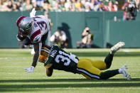 New England Patriots running back Damien Harris (37) is tackled by Green Bay Packers safety Adrian Amos (31) during the first half of an NFL football game, Sunday, Oct. 2, 2022, in Green Bay, Wis. (AP Photo/Morry Gash)